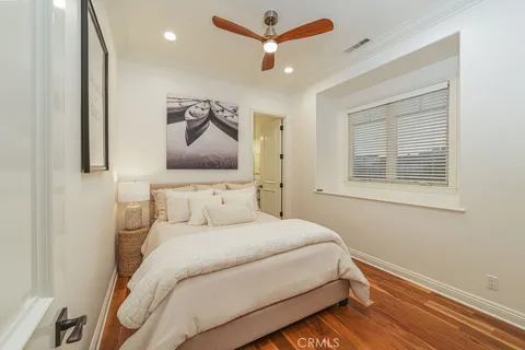 a bedroom with a bed and a painting on the wall