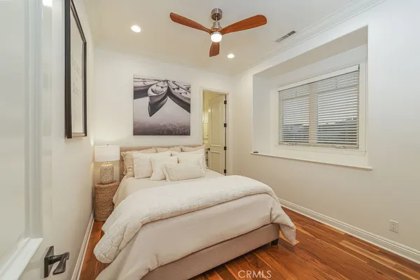 a bedroom with a bed and a painting on the wall