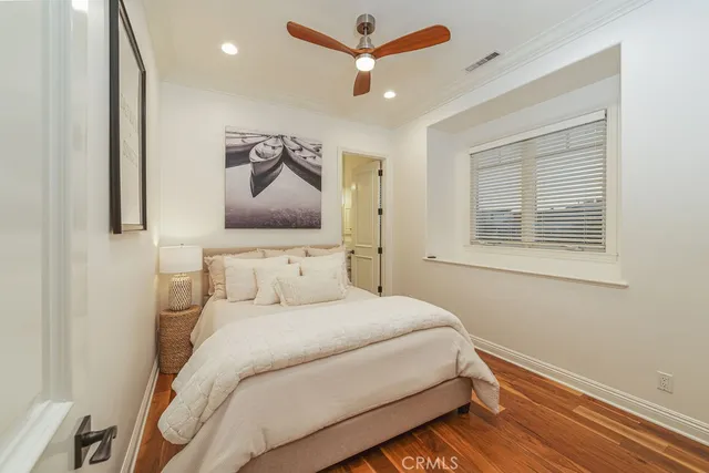 a bedroom with a bed and a painting on the wall