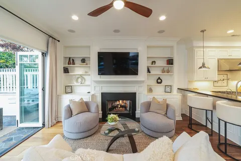 a dining room with furniture a chandelier and wooden floor