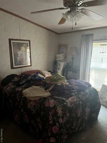 a bedroom with a bed and dresser