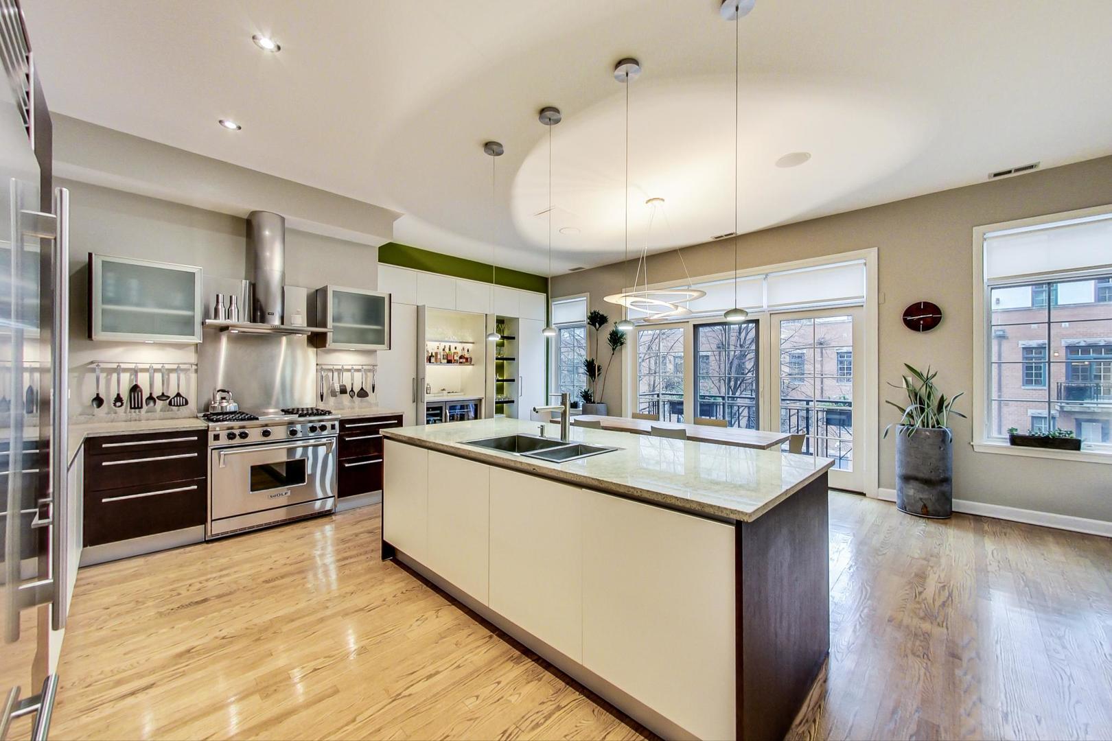 357 West Superior Street, Unit AB Chicago, IL 60654 - Photo 12 of 50 a kitchen with stainless steel appliances granite countertop a stove and cabinets
