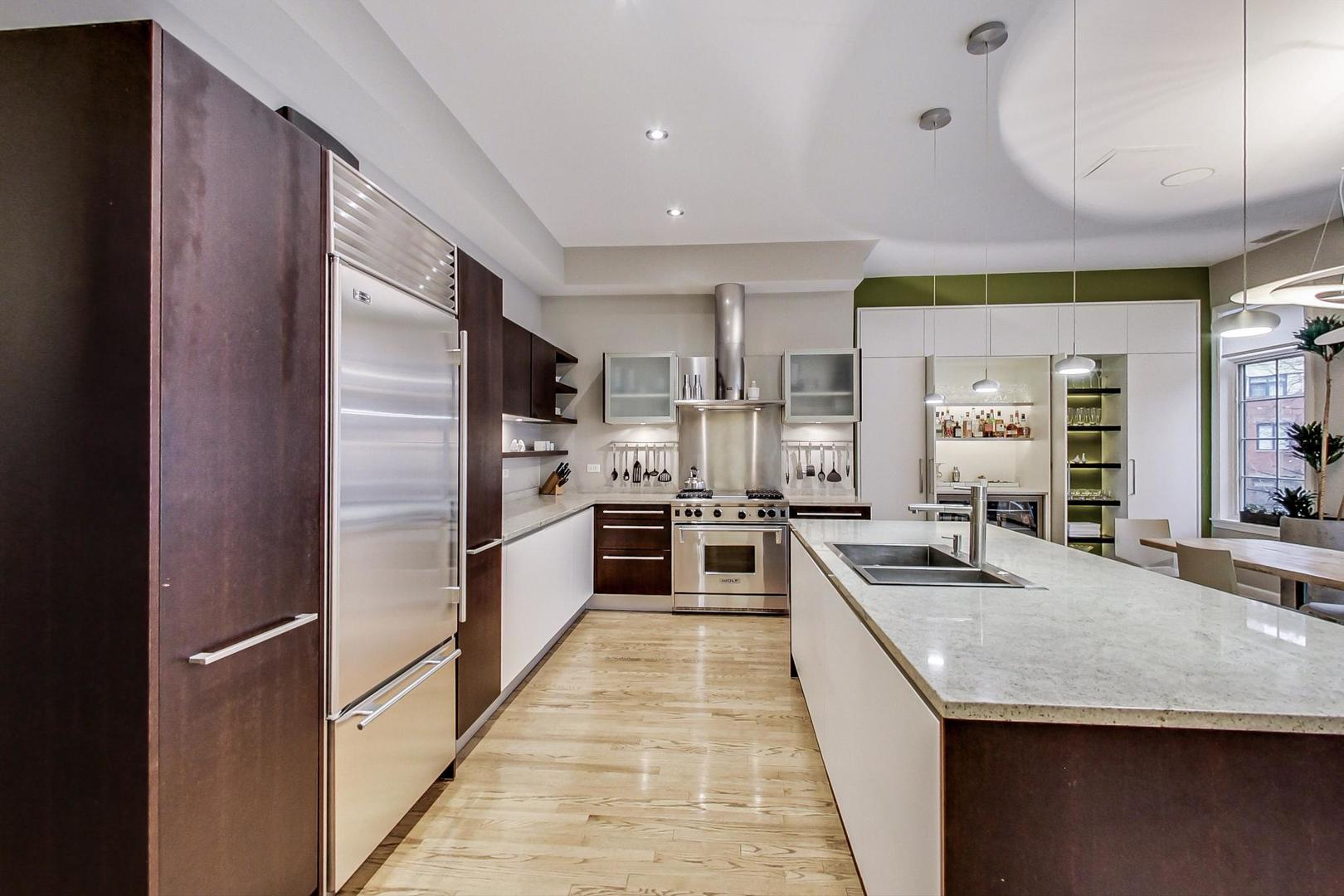 357 West Superior Street, Unit AB Chicago, IL 60654 - Photo 13 of 50 a large kitchen with stainless steel appliances granite countertop a large counter top a stove a chimney a sink and a refrigerator