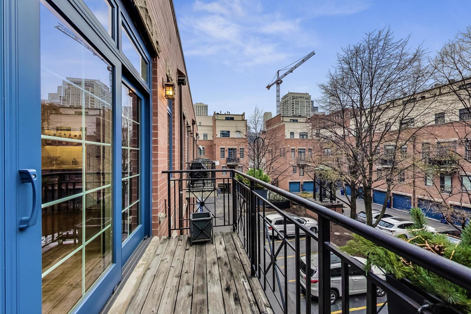357 West Superior Street, Unit AB Chicago, IL 60654 - Photo 16 of 50 a view of balcony with a floor to ceiling window with wooden floor