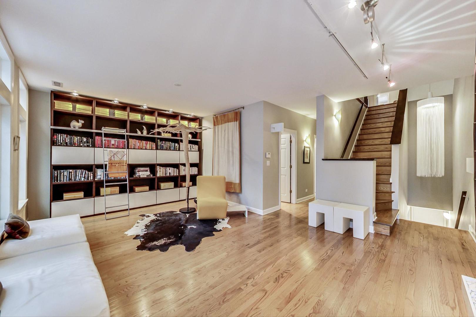 357 West Superior Street, Unit AB Chicago, IL 60654 - Photo 2 of 50 a living room with lots of furniture and white walls