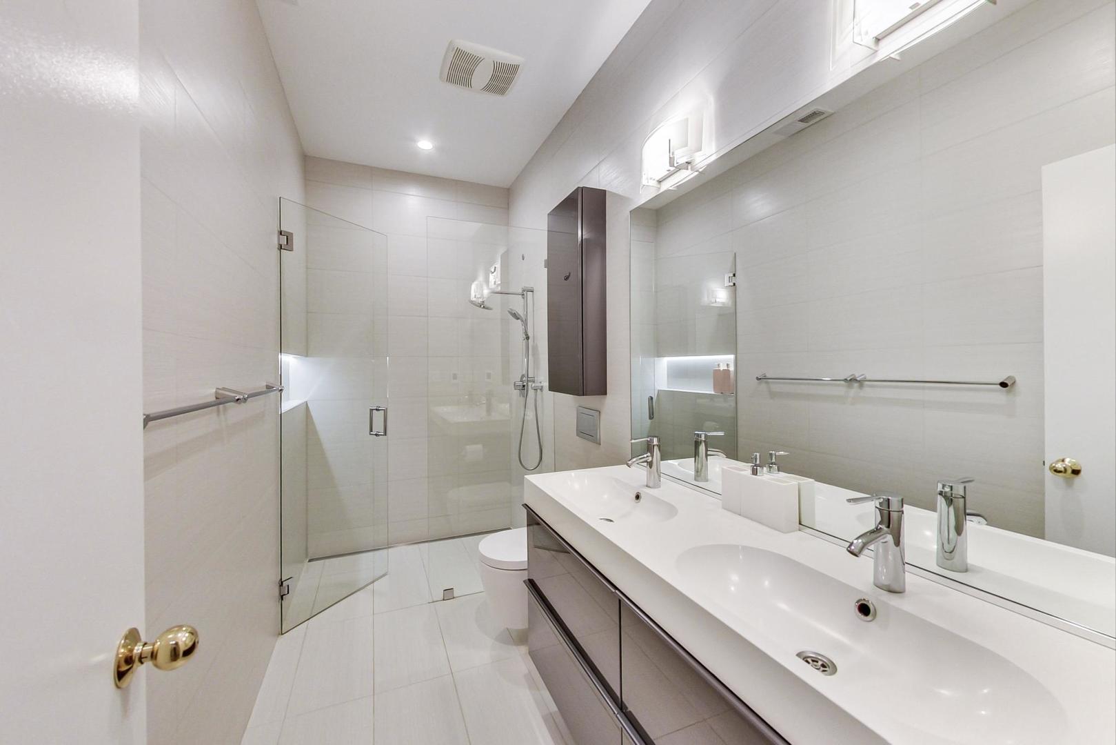 357 West Superior Street, Unit AB Chicago, IL 60654 - Photo 26 of 50 a en suite bathroom with a double vanity sink mirror and shower