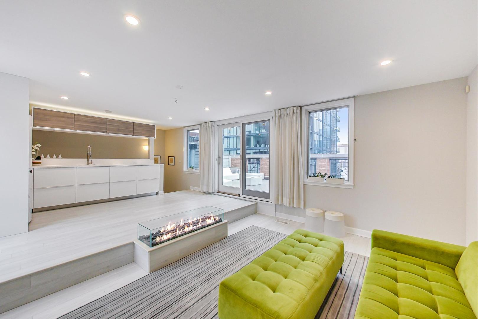 357 West Superior Street, Unit AB Chicago, IL 60654 - Photo 27 of 50 a spacious bedroom with a bed and a couch