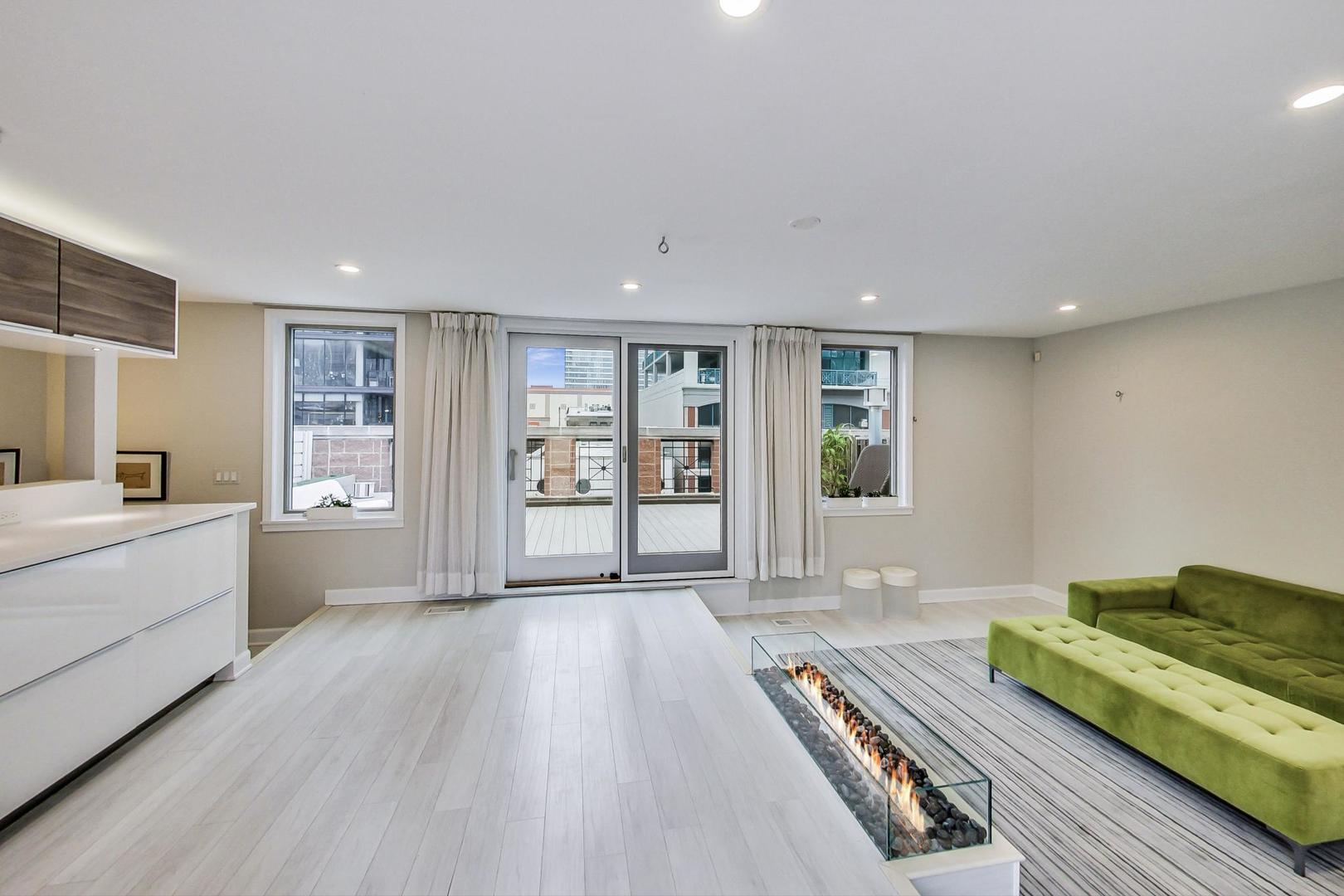 357 West Superior Street, Unit AB Chicago, IL 60654 - Photo 28 of 50 a spacious bedroom with a large bed and a window