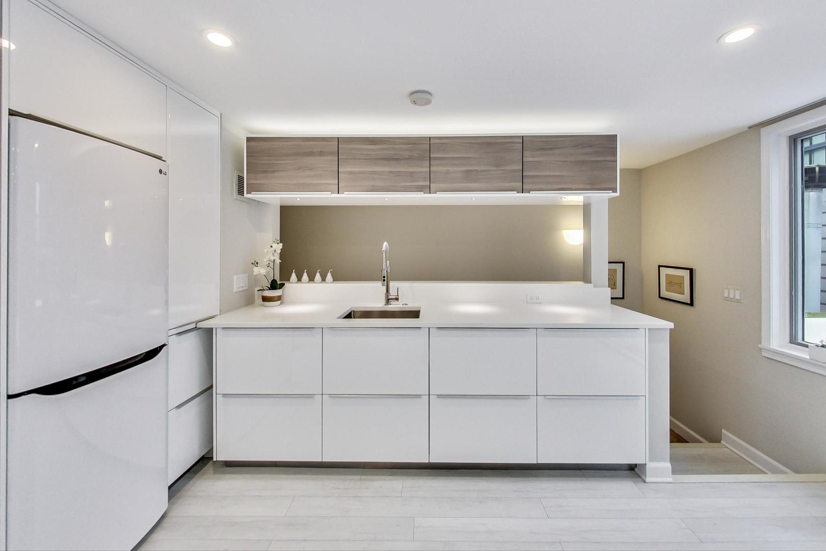 357 West Superior Street, Unit AB Chicago, IL 60654 - Photo 29 of 50 a bathroom with a sink and a mirror