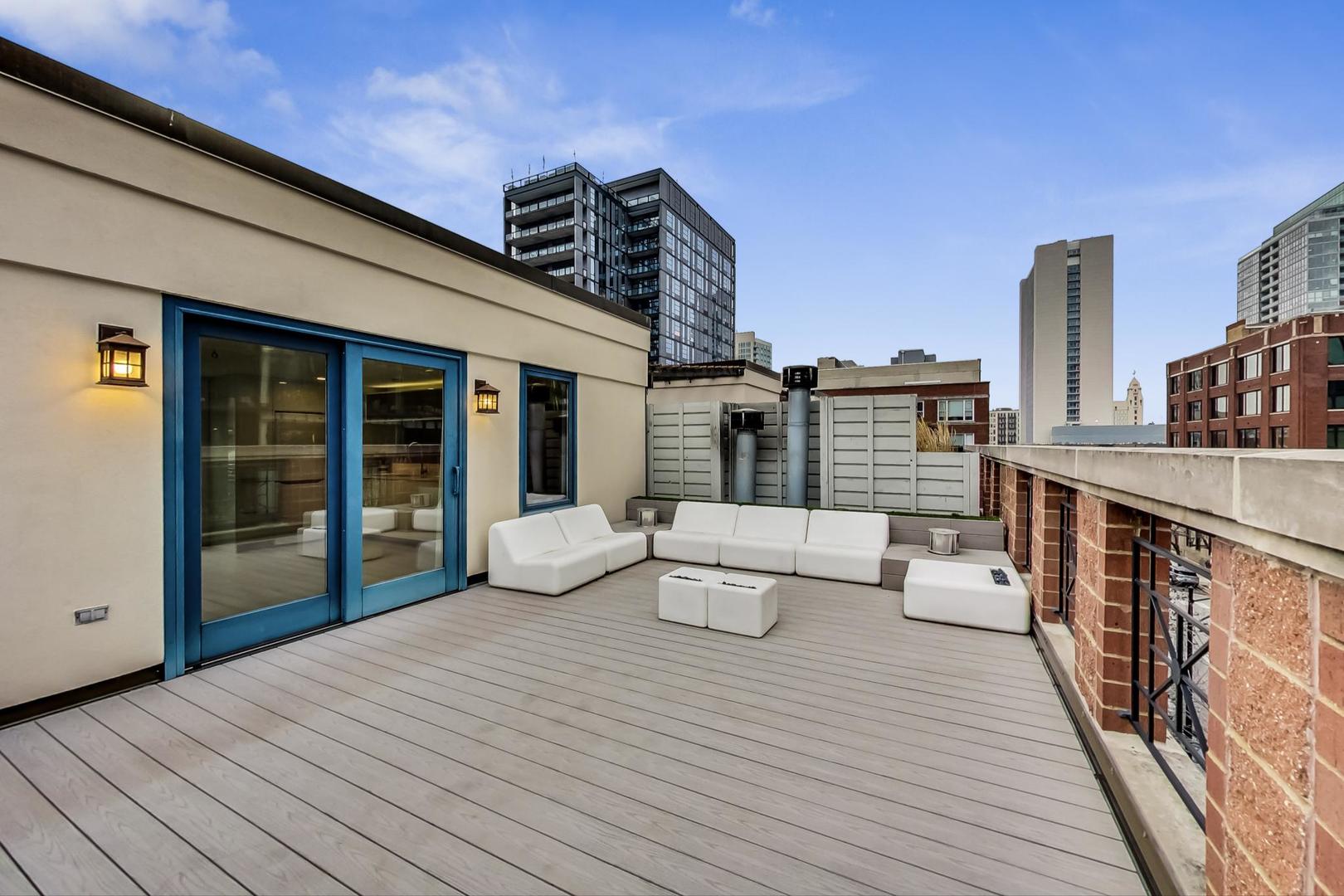 357 West Superior Street, Unit AB Chicago, IL 60654 - Photo 32 of 50 a view of balcony with couch and wooden floor