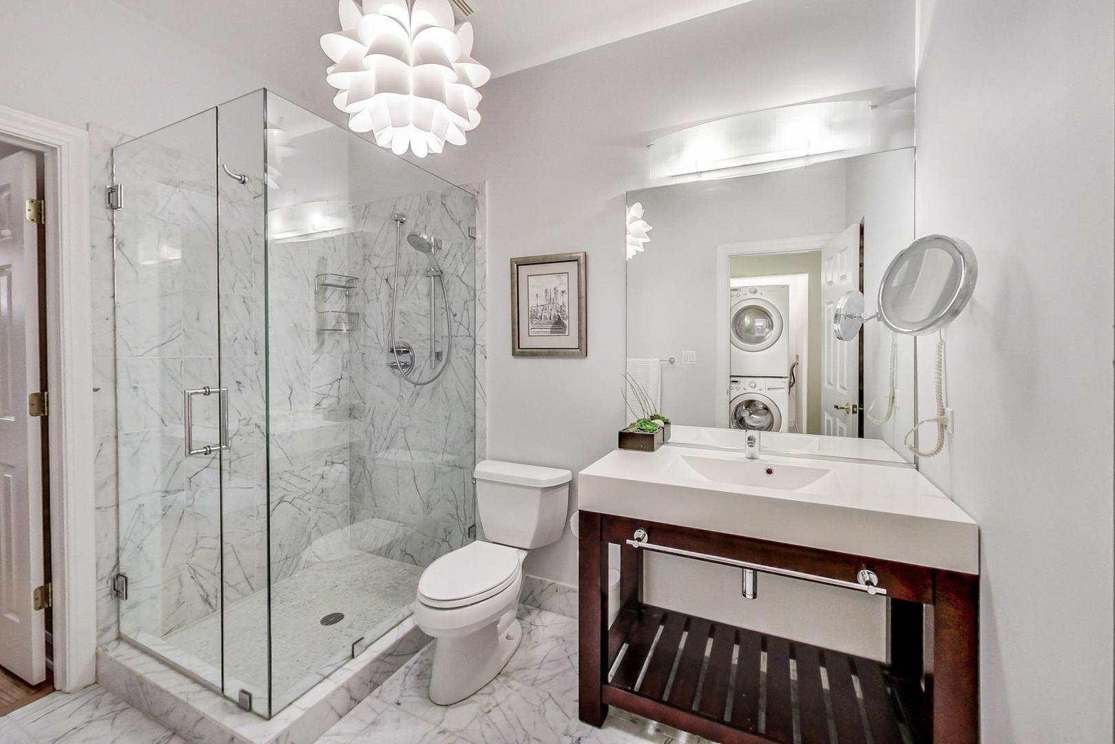 357 West Superior Street, Unit AB Chicago, IL 60654 - Photo 35 of 50 a bathroom with a sink a toilet and shower