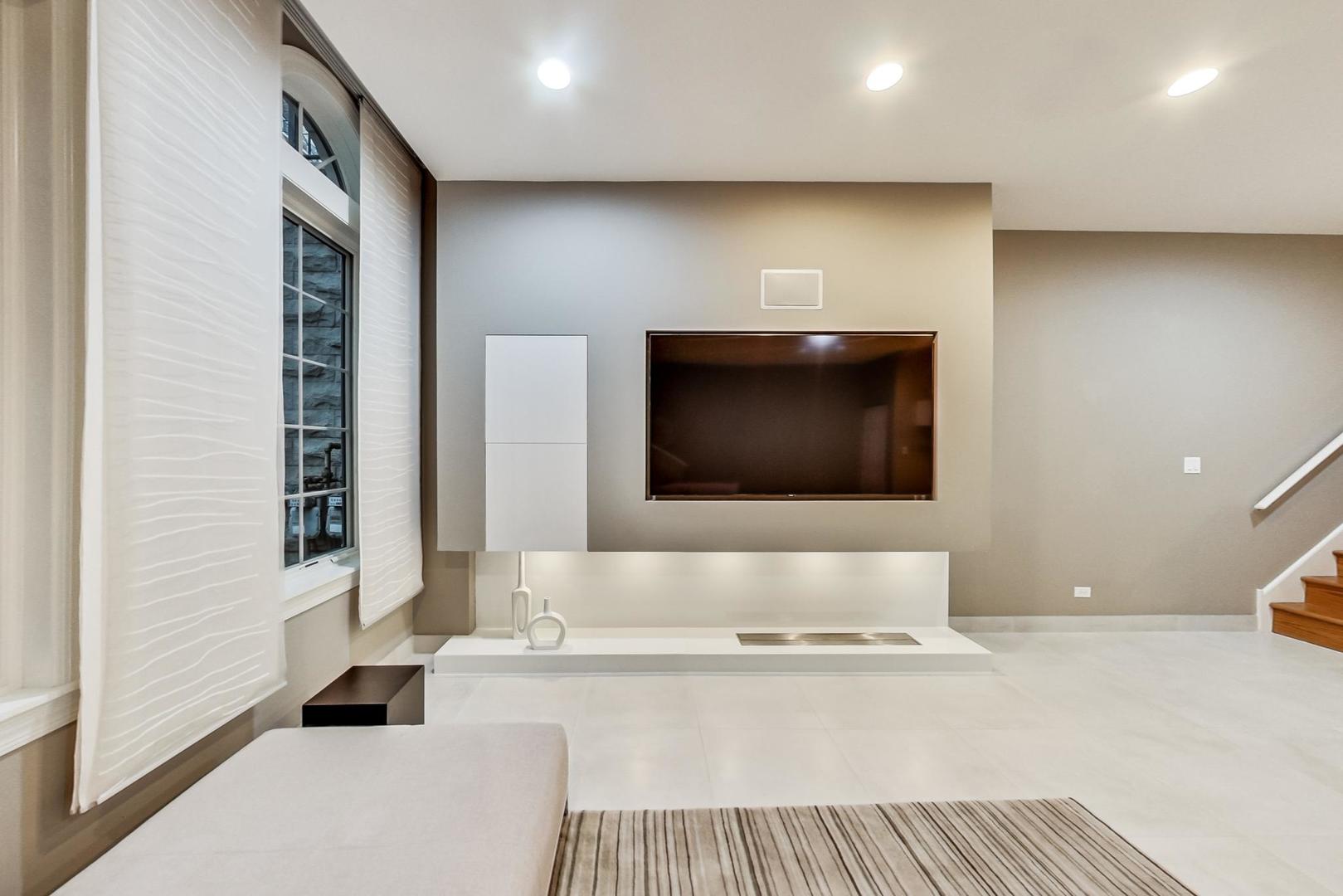 357 West Superior Street, Unit AB Chicago, IL 60654 - Photo 39 of 50 a living room with a couch and a flat screen tv