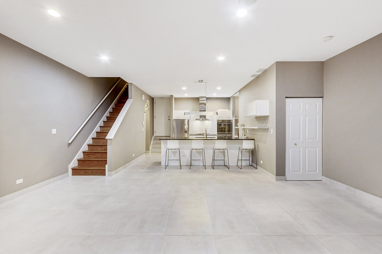 357 West Superior Street, Unit AB Chicago, IL 60654 - Photo 41 of 50 a kitchen with white cabinets and chair