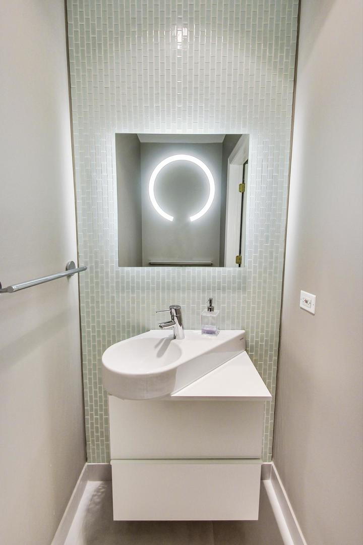 357 West Superior Street, Unit AB Chicago, IL 60654 - Photo 42 of 50 a bathroom with a sink and a mirror