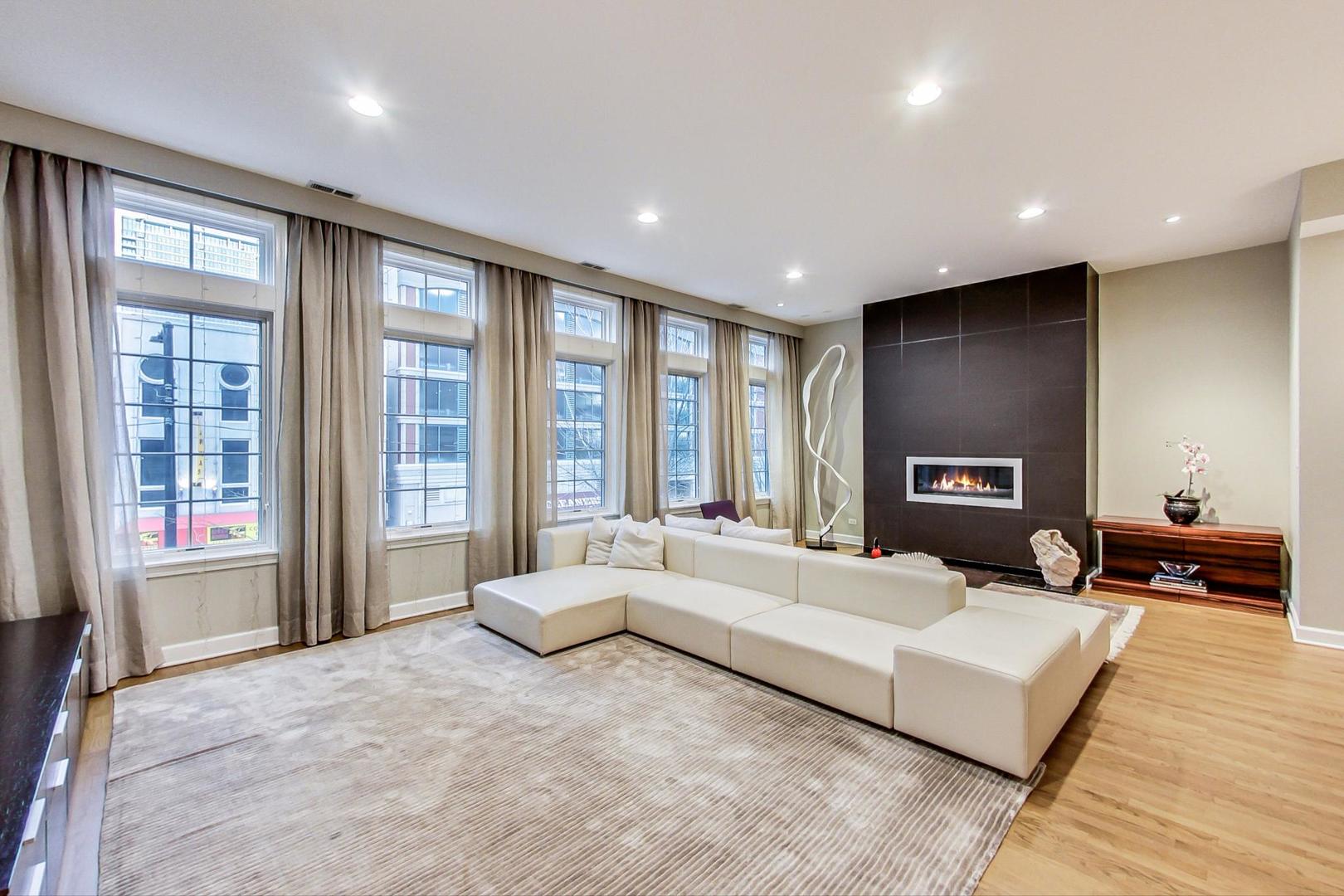 357 West Superior Street, Unit AB Chicago, IL 60654 - Photo 5 of 50 a large bedroom with a large bed and large window