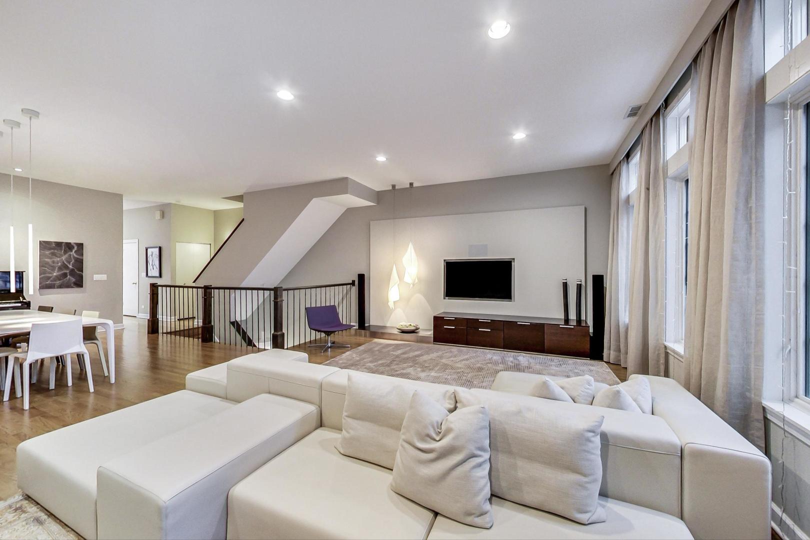 357 West Superior Street, Unit AB Chicago, IL 60654 - Photo 10 of 50 a living room with furniture a flat screen tv and a large window