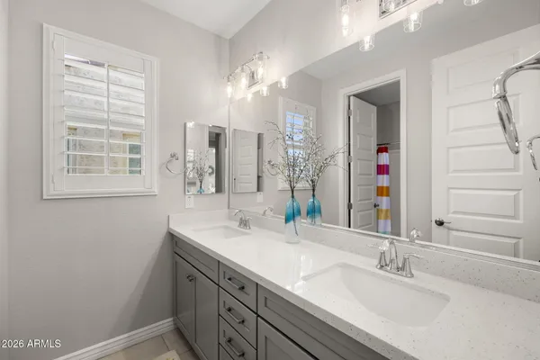 a bathroom with a sink double vanity and a mirror