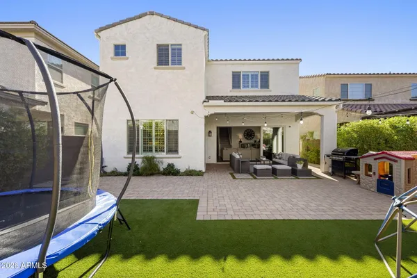 a view of a house with backyard porch and sitting area