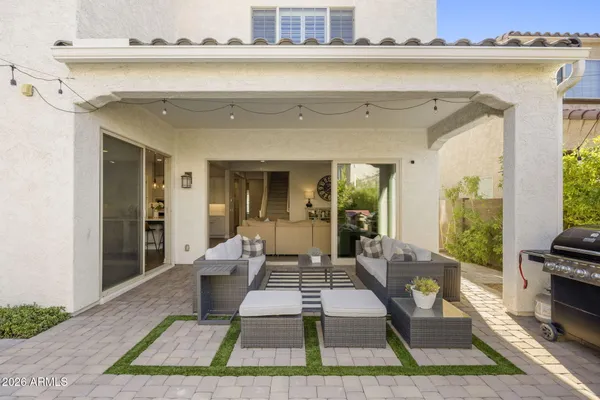 a living room with furniture rug and wooden floor