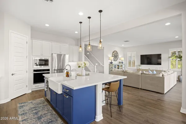 a kitchen with a sink a counter top space appliances and cabinets
