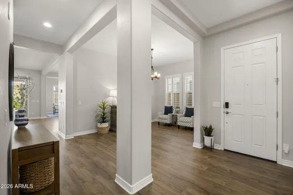 a view of a livingroom with wooden floor and furniture