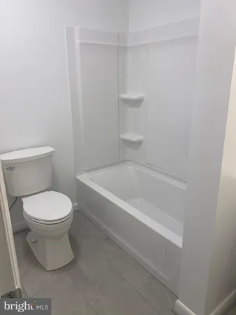 a bathroom with a toilet and a bathtub