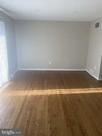 an empty room with wooden floor