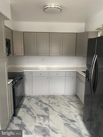 a kitchen with a refrigerator and a sink