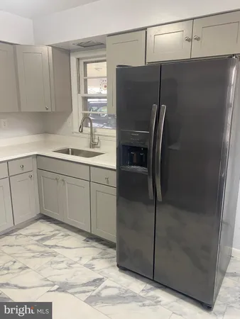 a kitchen with stainless steel appliances a refrigerator and cabinets