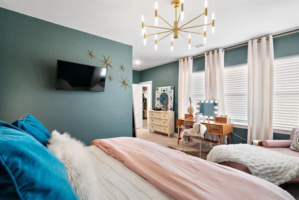 a bedroom with two beds and a flat screen tv