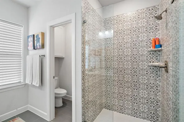 a bathroom with a toilet and a shower