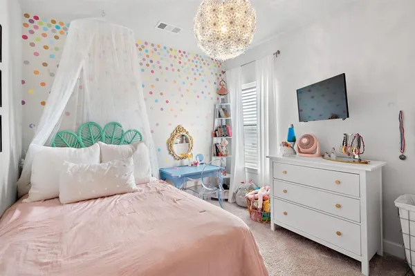 a bedroom with a bed and a table in it