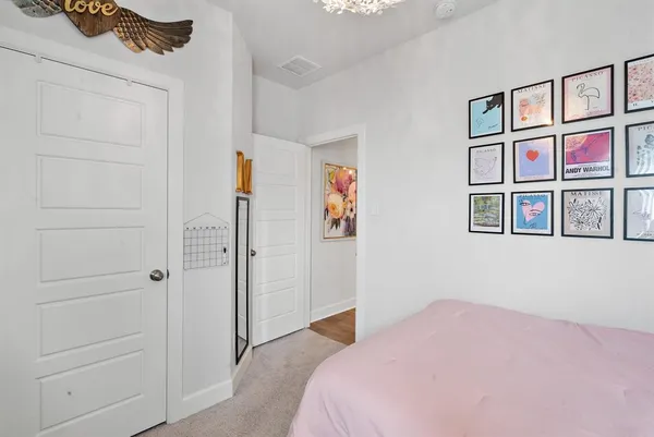 a bedroom with a bed and a cabinet