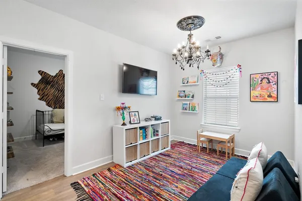 a bedroom with furniture and a chandelier