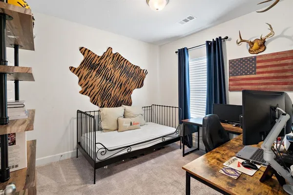 a bedroom with furniture and a window