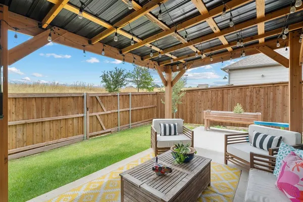 a view of a patio with couches chairs and a table and chairs with wooden floor