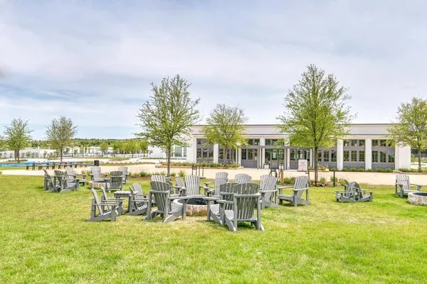 a view of a swimming pool with outdoor seating