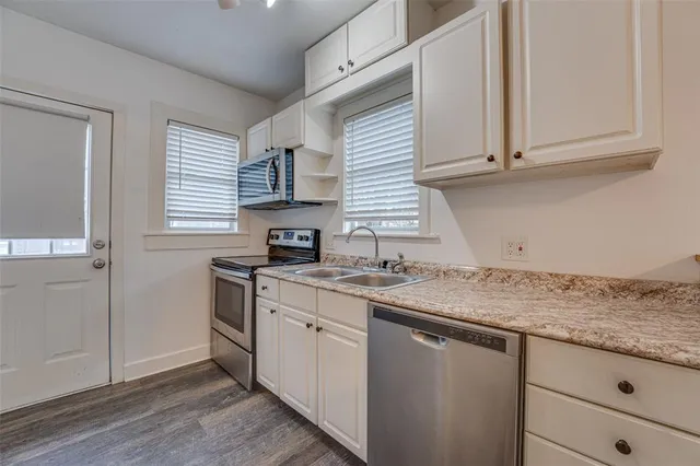 a kitchen with a sink and cabinets