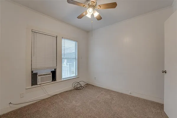 a view of a livingroom with a ceiling fan and window