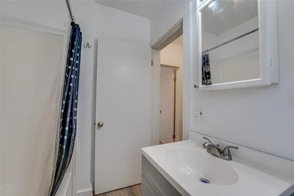 a bathroom with a tub and a sink