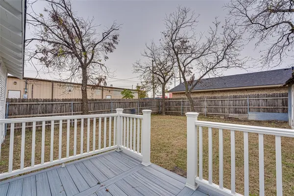 a view of a backyard with a tree