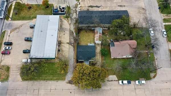 a front view of a house with a yard and large tree