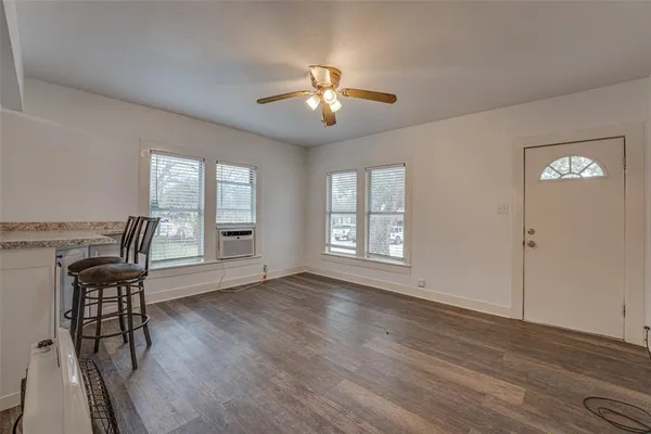 a view of a livingroom with furniture ceiling fan and wooden floor