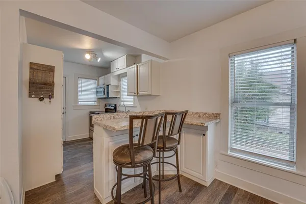 a kitchen with granite countertop a sink and a stove
