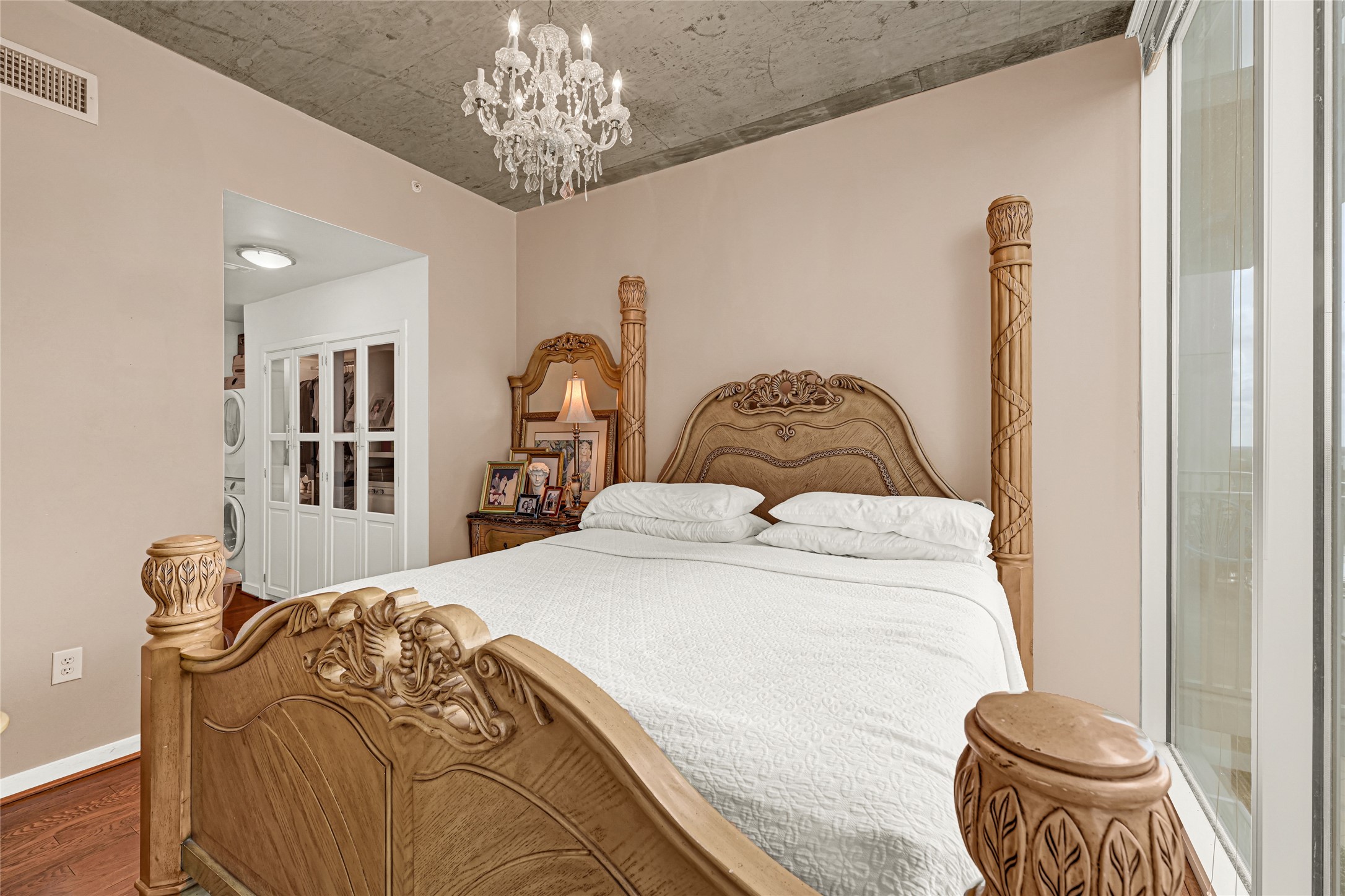 5925 Almeda Road, Unit 10908 Houston, TX 77004 - Photo 11 of 37 a bedroom with a bed and a chandelier