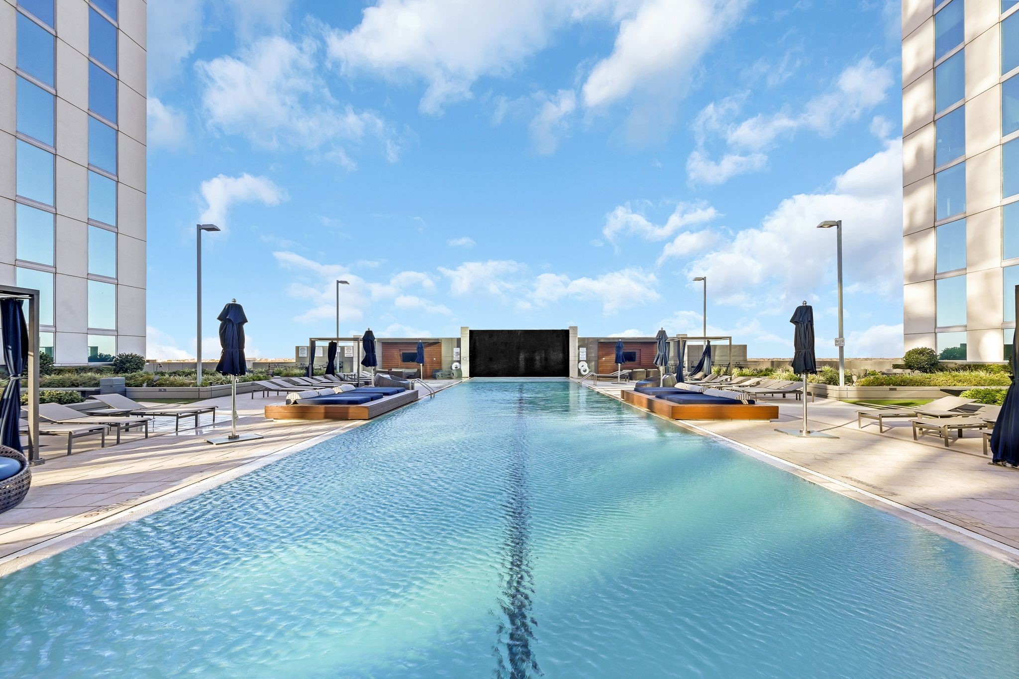 5925 Almeda Road, Unit 10908 Houston, TX 77004 - Photo 23 of 37 a view of a swimming pool with lawn chairs