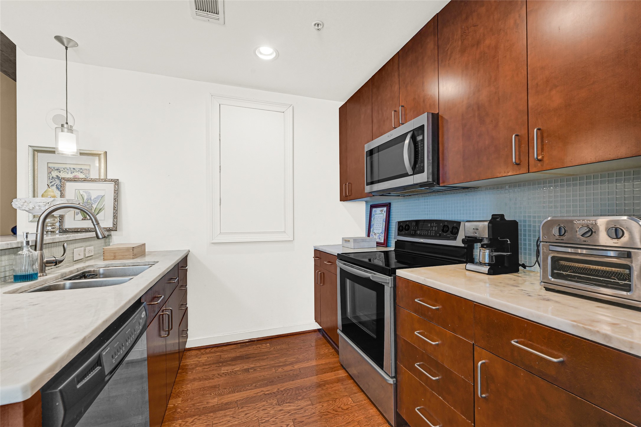 5925 Almeda Road, Unit 10908 Houston, TX 77004 - Photo 9 of 37 a kitchen with stainless steel appliances granite countertop a sink stove and microwave