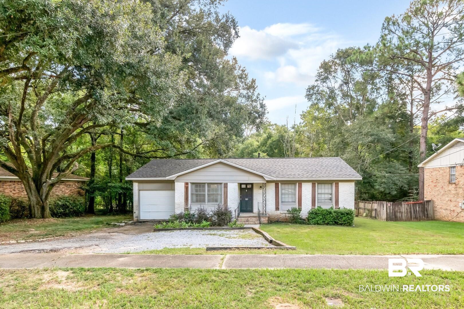 320 Vanderbilt Drive Mobile, AL 36608 - Photo 2 of 39 View of front of property featuring a front yard and a garage