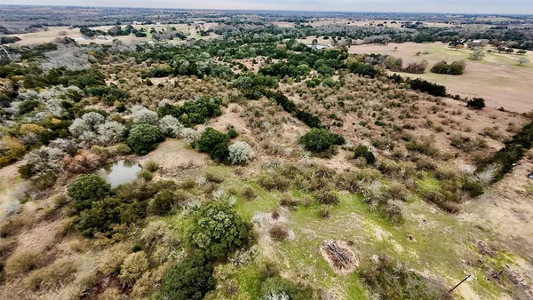 an aerial view of a houses with a yard
