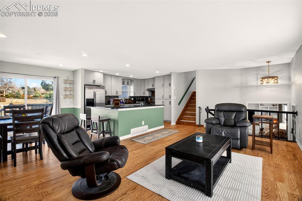 5226 Rocking R Drive Colorado Springs, CO 80915 - Photo 13 of 46 a living room with furniture and wooden floor